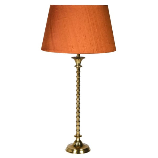 Delicate in its design but bold in its execution, this exquisite table lamp encompasses all the delight of modern design. Its elegant brass stem sits proudly on a flat, circular base providing the perfect support. light, brass light, brass lamp, gold lamp, orange lamp, tall lamp, stylish table lamp, table lamp,