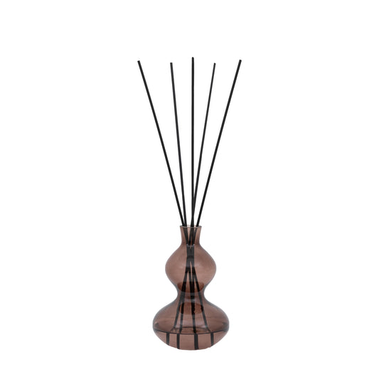 Brown glass reed diffuser with black reeds, featuring a sculptural curved silhouette and rose oud fragrance