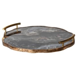 This elegant and bold accessory is perfect for adding dimension, interest and practicality to vignettes on consoles or coffee tables. Complete with two curved handles finished in a bronze metallic edging and the colouring of blue and grey hues this circular tray could be used any where in the home to elevate your styling.